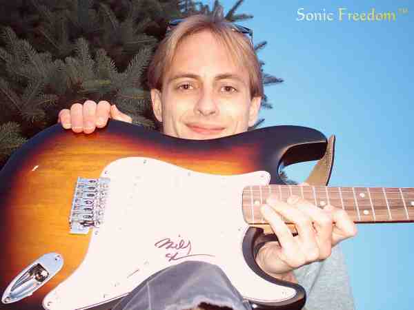 Tim holding Billy sheehan autographed guitar